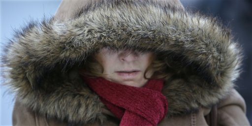 A Commuter bundles up against extreme cold conditions Tuesday in Chicago. Temperatures in the area were hovering around zero with sub-zero wind chill reading hitting 10 below.