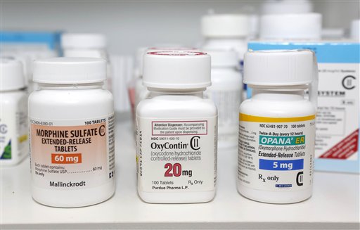 In this photo taken Friday, morphine sulfate, OxyContin and Opana are displayed for a photograph in Carmichael, Calif. Maine's best-in-the-nation record of turning in unwanted prescription medications for destruction is threatened by new U.S. Drug Enforcement Agency rules, which limit data collection on disposed drugs and how such drugs can be destroyed.