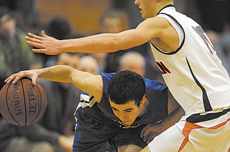 Erskine Academy's Devin Duncan, 10, passes Skowhegan Area High School defender Eli Holland, 10, right, in the fourth quarter at Skowhegan Area High School on Friday.