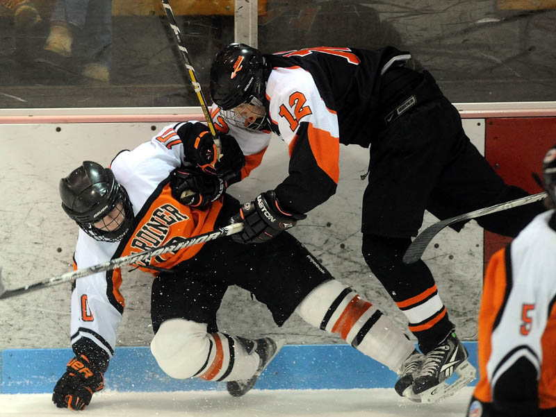 Staff photo by Michael G. Seamans CHECK MATE: Skowhegan High School’s Kameron Nelson, 12, checks Gardiner High School’s Austin Moore, 10, in the first period at Sukee Arena in Winslow on Saturday night.