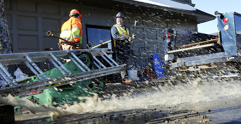 WATER SPOUT: Gardiner Water District Superintendent Paul Gray, left, and employee Jeff Minchin prepare to repair a leaking line Thursday January 3, 2013 in Gardiner. An old service line broke, Gray said, flooding a basement. Cold weather was not the cause of leak, according to Gray, but "these never seem to happen in July."