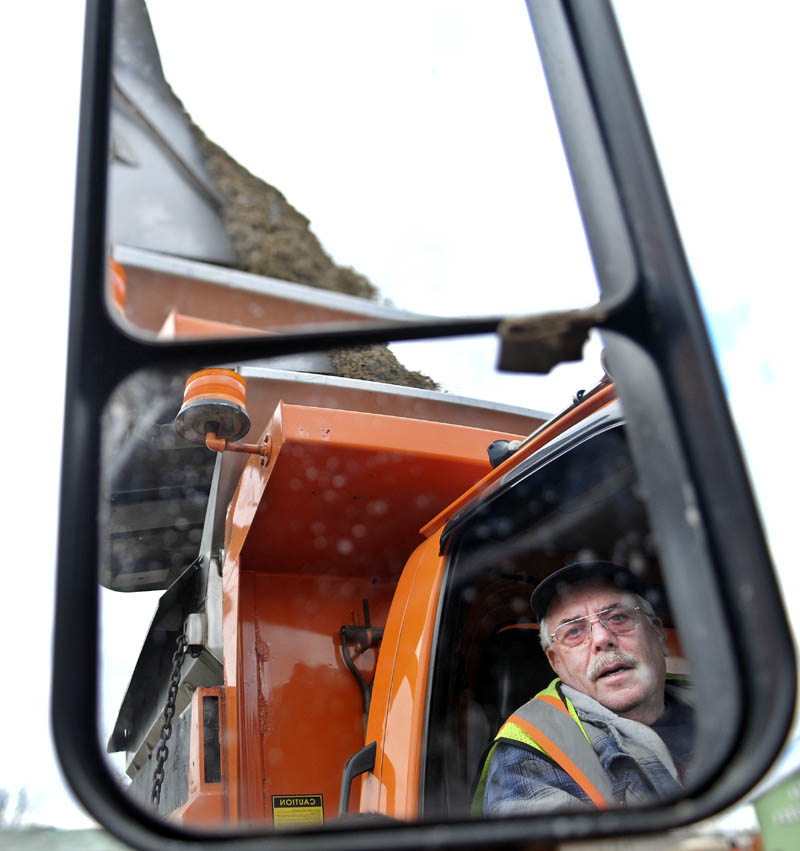 Augusta Public Works employee David Snide watches a load of salt and sand get dumped Tuesday into bed of the snowplow he operates. Snow is on tap for Wednesday, following balmy temperatures Monday, according to weather reports. "I love the snow," Snide said. "Snow is just like money coming down. It's good for the businesses that rely on it."