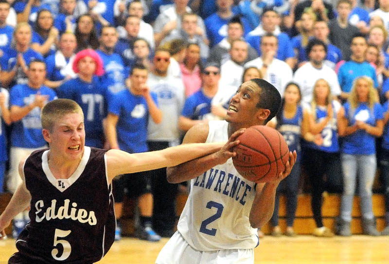 Lawrence High School's Xavier Lewis, 2, draws the foul from Edward Little High School's Ian Mileikis, 5, in the third quarter in Fairfield Friday night.