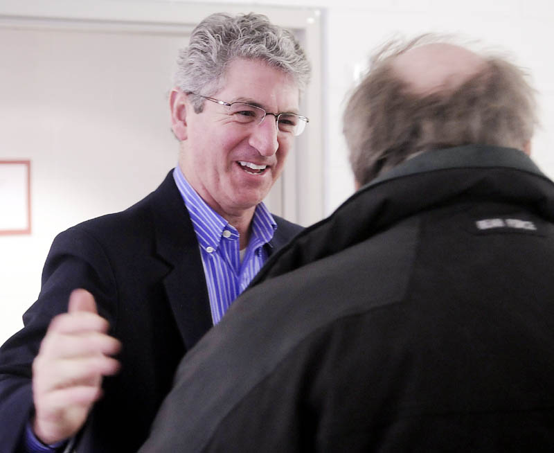 William Stokes, left, greets a voter while campaigning earlier in Augusta in May 2011.