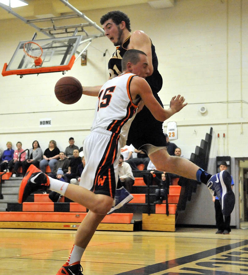 Medomak Valley High School's Ryan Ripley, right tries to throw the ball off of Winslow High School's Justin Kervin before going out of bounds in the first quarter Tuesday at Winslow High School. Winslow defeated Medomak Valley 73-61.