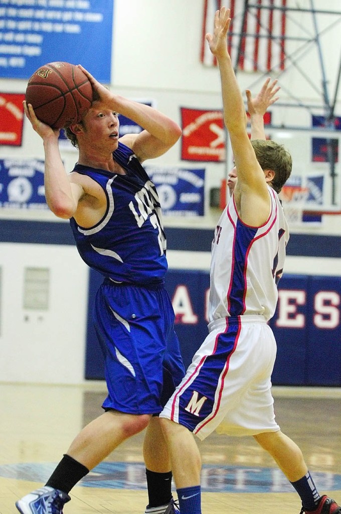 Lawrence's Matt Saunders, left, looks for an outlet pass around Messalonskee's Quinn Warren during a game on Friday night at Messalonskee High School.