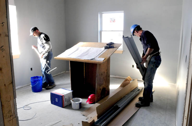 Art O'Brien, left, and Richard Hjort work on the Winslow police chief's office in the new department renovations project on Dec. 20. Town councilors are scheduled to tour the renovated station on Monday.