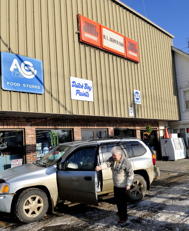Albion resident Charlene Quimby gets out of a vehicle at the H.L. Keay & Son store in Albion on Wednesday. The store is closing, probably this week, after 86 years in business. "It's a tragedy they are closing," Quimby said. "Harold and his son Crosby were so generous to the community." She added that shoppers could always get what they wanted without driving to bigger stores.