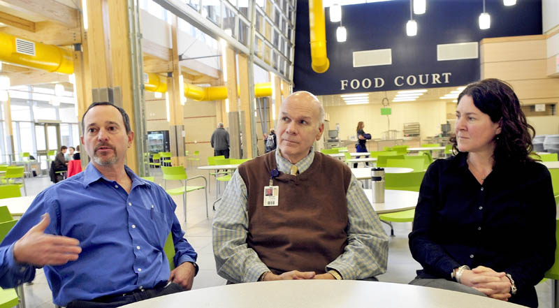 Glenn Kapiloff, left, director of career and technology education, Regional School Unit 9 Superintendent Michael Cormier and Mt. Blue High School Principal Monique Poulin discuss progress of the three-year expansion project at the Farmington school recently.