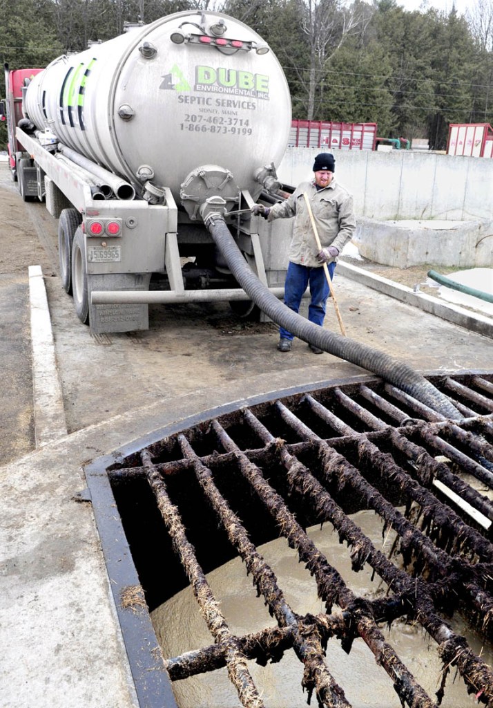 John Wintle watches as food waste is unloaded in one of the receiving tanks at Exeter Agri-Energy, at the Stonyvale dairy farm in Exeter. The waste is mixed with cow manure and produces gas that is used to power a generator to make electricity.