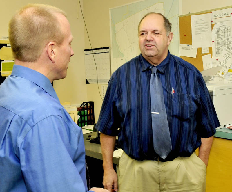 Warren Hatch, right, speaks with Clinton Police Chief Craig Johnson on Wednesday. Hatch has been hired as the new Clinton town manager.