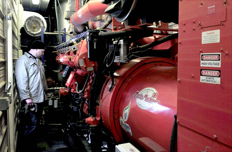 John Wintle monitors the engine inside the control room, where gas produced by mixing cow manure and food waste powers a generator and produces 5.2 million kilowatt-hours of electricity, at the Stonyvale Farm in Exeter.