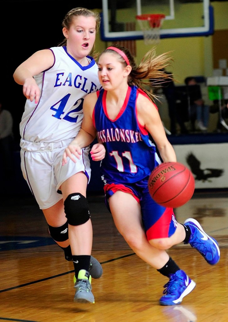 Erskine's Mallory Chamberlain, left, tries to stop Messalonskee's Nicole Collier during a game on Friday in the James V. Nelson Gym at Erskine Academy.