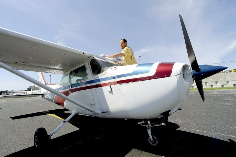 A local pilot prepares for a flight in a Cessna 172 last summer in Portland. The LePage administration is seeking a permanent sales tax exemption on airplanes and parts.