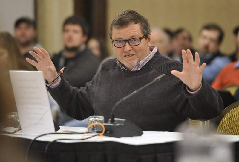 Jim Odlin, who owns three fishing boats out of Portland, questions fishery scientists after their presentation at the New England Fishery Management Council meeting Wednesday in Portsmouth, N.H.