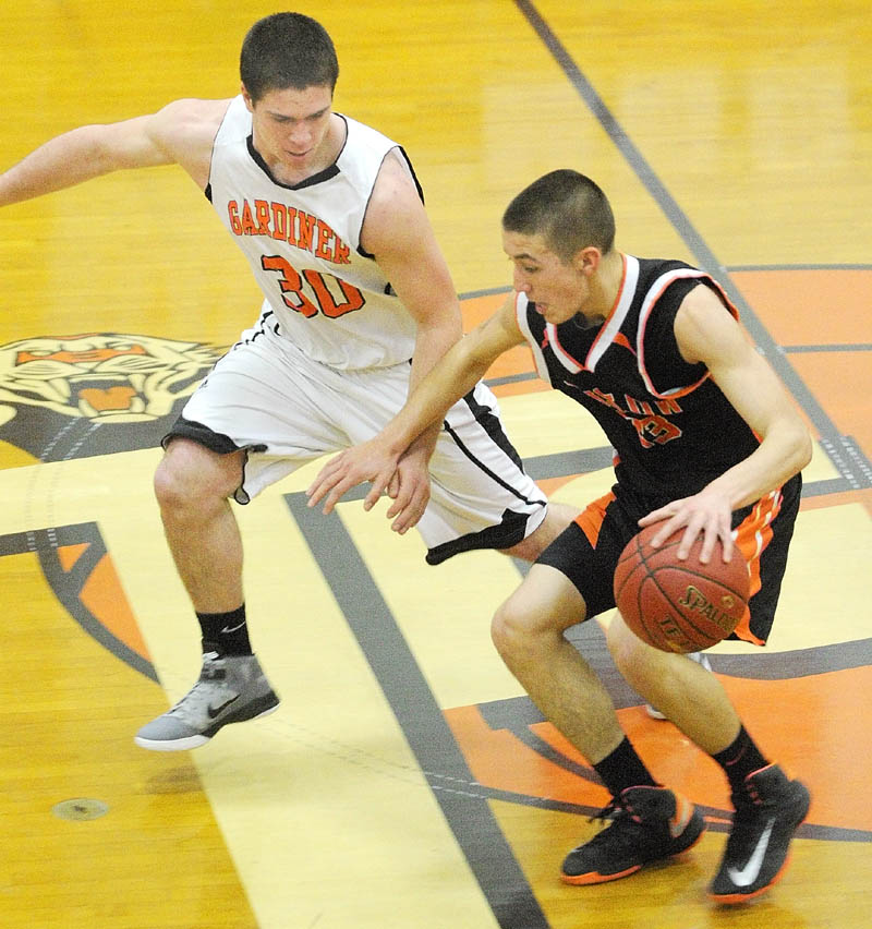 TIGHT DEFENSE: Gardiner’s Dennis Meehan, left, covers Winslow’s Nason Lanphier at midcourt during the Black Raiders 58-48 win Saturday at the John A. Bragoli Memorial Gym in Gardiner.