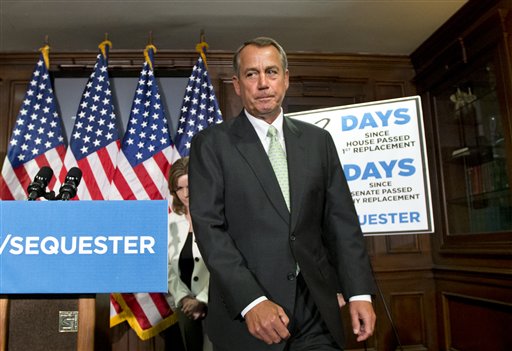 House Speaker John Boehner, R-Ohio, wraps up a news conference on Capitol Hill on Tuesday, where he and GOP leaders challenged President Obama and the Senate to avoid the automatic spending cuts set to take effect in four days. Boehner complained that the House, with Republicans in the majority, has twice passed bills that would replace the across-the-board cuts known as the "sequester" with more targeted reductions, while the Senate, controlled by the Democrats, has not acted. He is followed by Rep. Lynn Jenkins, R-Kansas is at left. (AP Photo/J. Scott Applewhite)