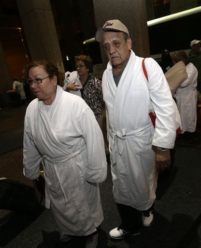 Weary passengers from the disabled Carnival Triumph cruise ship arrive by bus at the Hilton Riverside Hotel in New Orleans on Friday.
