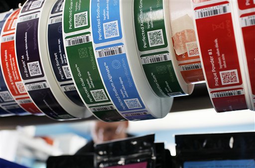 Colorful product labels frame shipper John McWilliams of Kittery at the Modernist Pantry warehouse in Eliot.