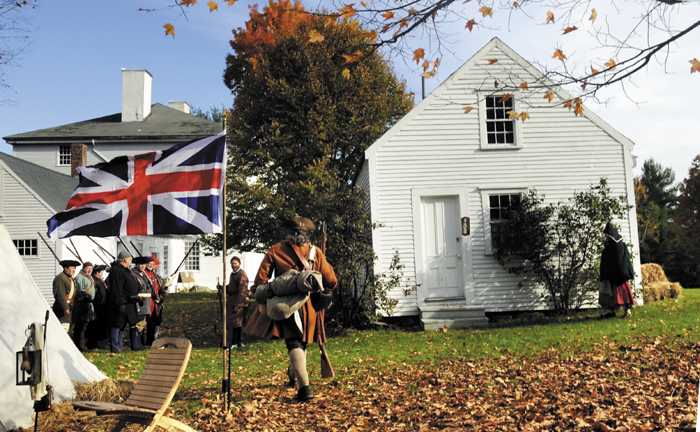 Re-enactors assemble on the lawn of the Pownalborough Court House, in Dresden, on Sunday, after sleeping in tents outside the 18th century building overnight.