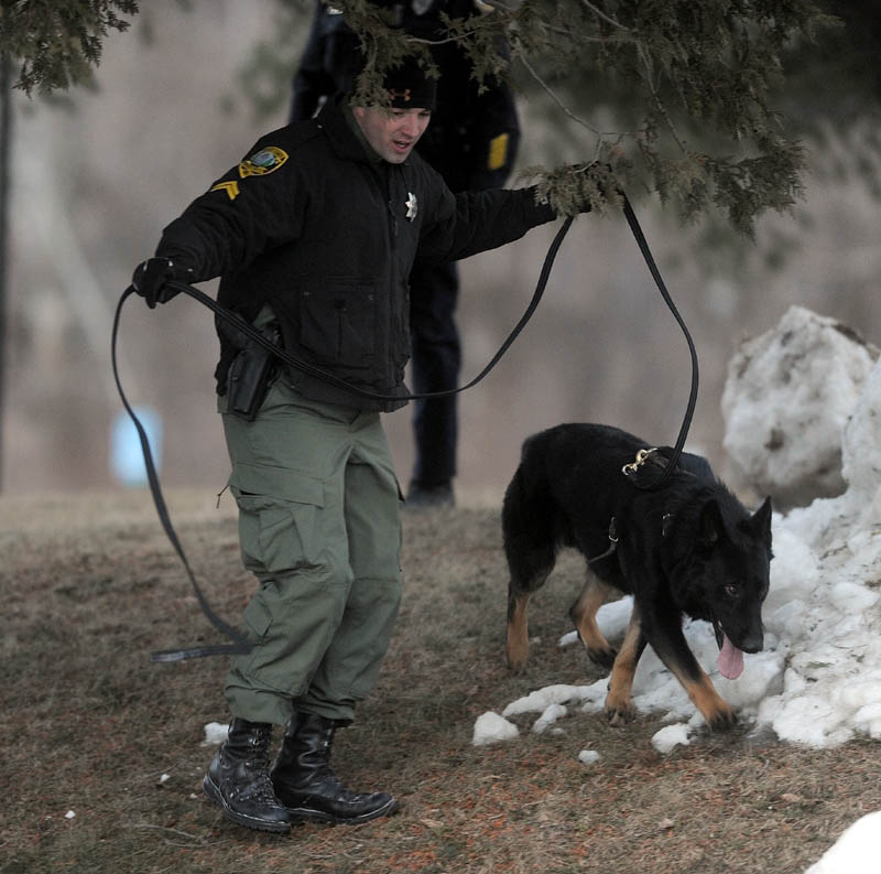 A Kennebec County Sheriff K-9 unit searches the area around Key Bank on Kennedy Memorial Drive Thursday after a man robbed the place and made off with an undisclosed amount of money.