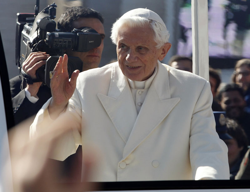Pope Benedict XVI greets pilgrims in St. Peter's Square at the Vatican, Wednesday, Feb. 27, 2013. Pope Benedict XVI greeted the Catholic masses in St. Peter's Square Wednesday for the last time before retiring, making several rounds of the square as crowds cheered wildly and stopping to kiss a half-dozen children brought up to him by his secretary. (AP Photo/Michael Sohn)