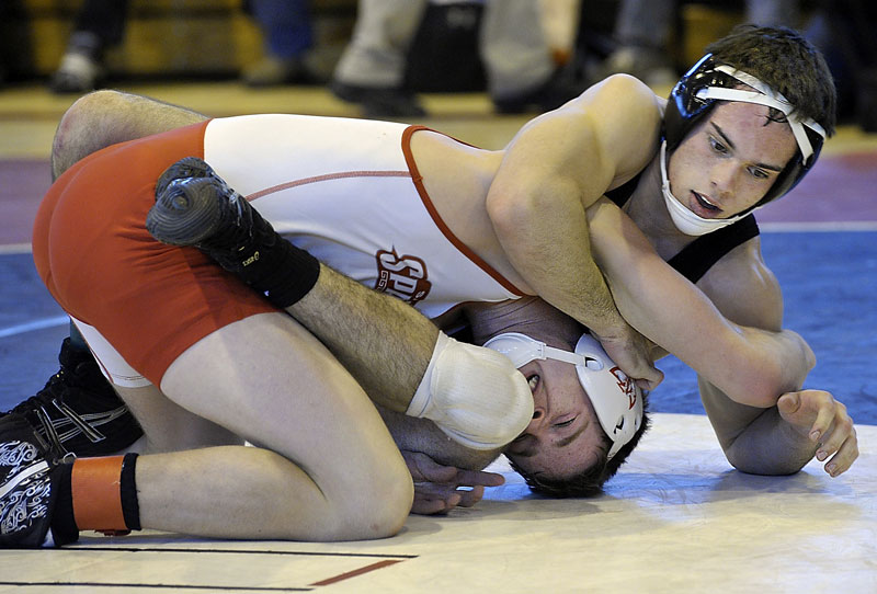 STRETCHING IT OUT: Skowhegan’s Kaleb Brown gets the best of Sanford’s Josh Downs in the semifinals of the 138-pound weight class at the Class A Wrestling State Championships at Sanford High School. Brown won.