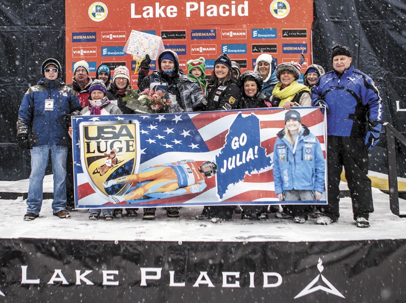 FAMILY AFFAIR: Julia Clukey, center, poses with family and friends after earning her first podium finish in a World Cup luge race Friday in Lake Placid, N.Y. Clukey finished second Friday, just .295 seconds behind Germany’s Natalie Geisenberger.