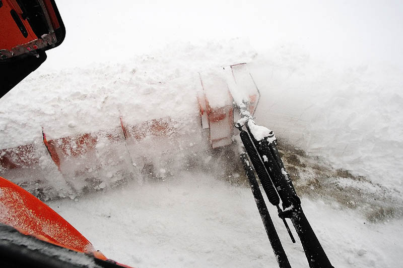 Snow flies of the wing plow on the side of the truck driven by Augusta Public Works plow truck driver Stan Moore on Saturday.