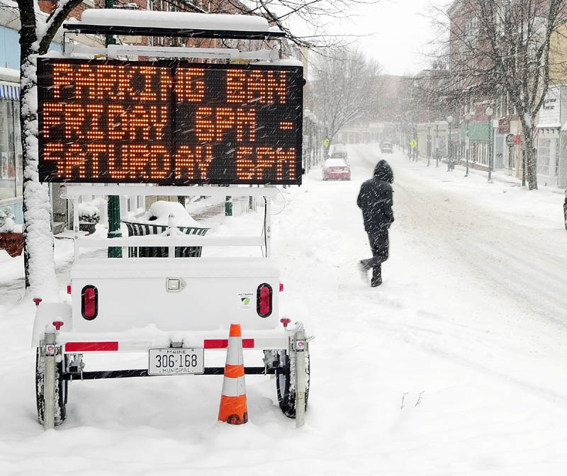 Staff photo by Joe Phelan A flashing sign on Water Street announces the parking ban on all streets in the city of Gardiner starting at 6 pm. on Friday February 8, 2013 .