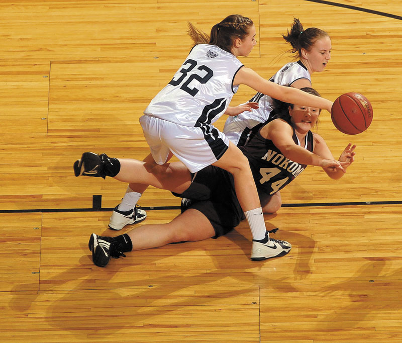 Mikayla Charters (44) of Nokomis looks to pass the ball after diving for possession against Presque Isle during the Eastern Class B championship game Saturday at the Bangor Auditorium. Presque Isle won, 66-51.