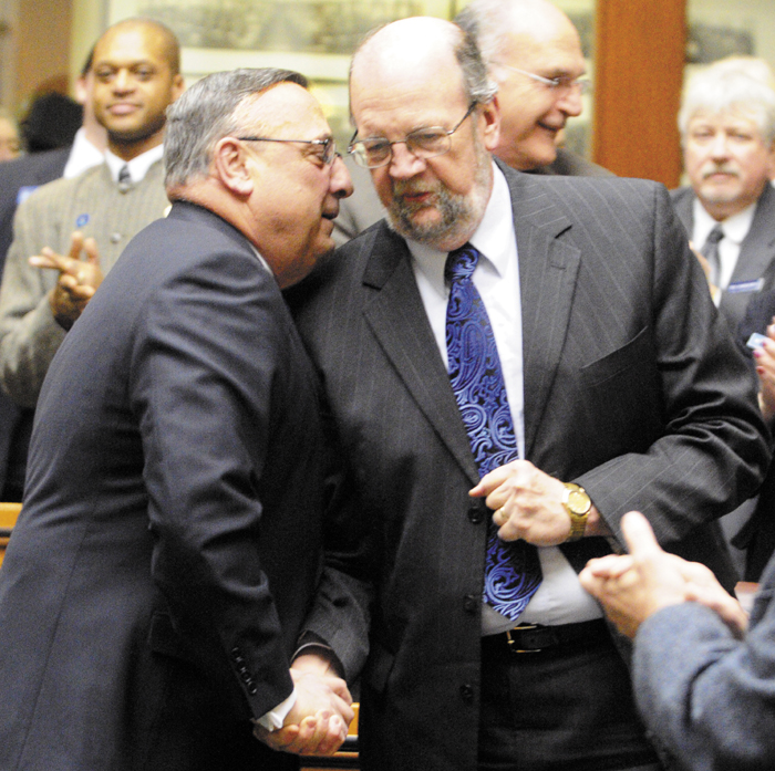 Gov. Paul LePage, left, chats with Rep. Robert Nutting, R-Oakland, as he enters the House chamber to give his State of the State address on Tuesday, in the State House in Augusta.