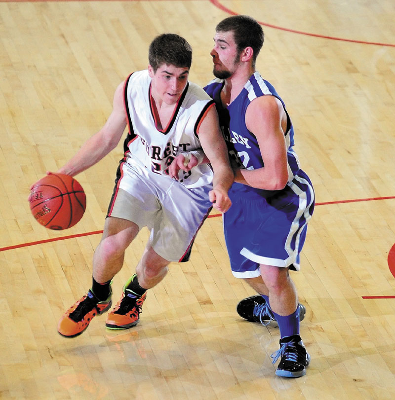 Forest Hills' Evan Worster, left, drives past Valley's Josh West during the Western Maine Class D championship game Saturday at the Augusta Civic Center.