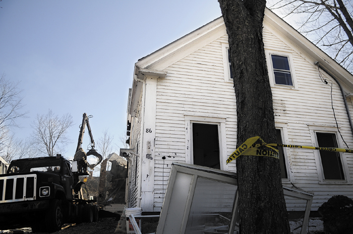 A worker removes materials from the interior of the former Umberhine Public Library building in Richmond while demolishing it on March 28, 2011.
