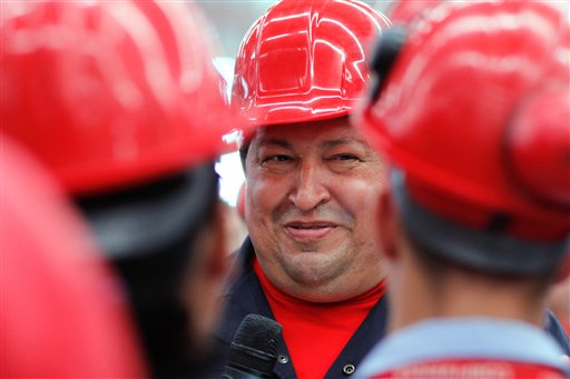 In this file photo released by Miraflores Press Office, Venezuela's President Hugo Chavez speaks with workers as he visits a truck factory in Barinas, Venezuela on Tuesday Feb. 21, 2012. Venezuela's Vice President Nicolas Maduro announced on Tuesday, March 5, 2013 that Chavez has died. Chavez, 58, was first diagnosed with cancer in June 2011. (AP Photo/Leslie Mazoch)