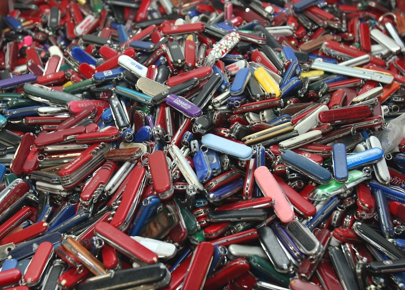 In this Sept. 26, 2006, file photo, knives of all sizes and types are piled in a box at the State of Georgia Surplus Property Division store in Tucker, Ga., and are just a few of the hundreds of items discarded at the security checkpoints of Hartsfield-Jackson Atlanta International Airport that will be for sale at the store. Airline passengers will be able to carry small knives, souvenir baseball bats, golf clubs and other sports equipment onto planes beginning in April 2013 under a policy change announced Tuesday, March 5, 2013, by the head of the Transportation Security Administration administrator John Pistole. (AP Photo/Gene Blythe, File)