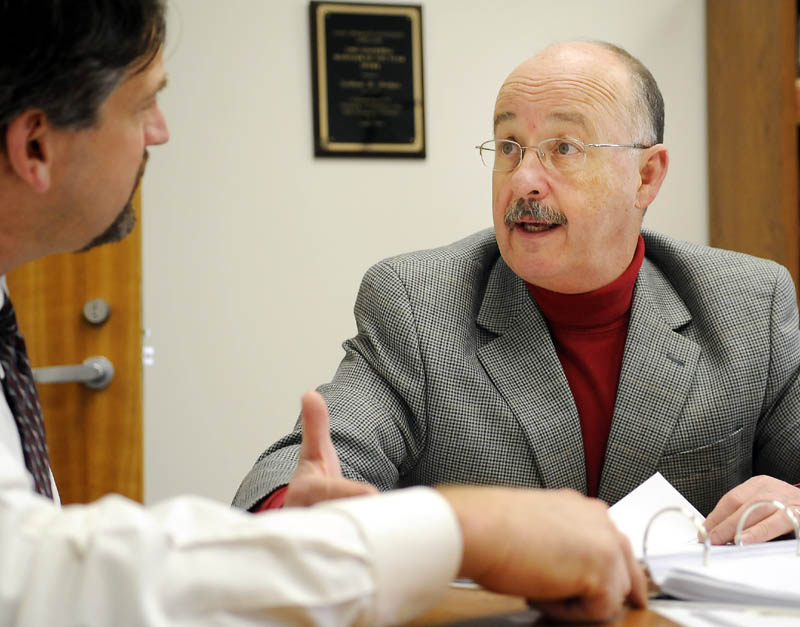 Augusta City Manager William Bridgeo, right, discusses the city’s 2012 budget with former Development Director Michael Duguay at the manager’s Augusta office on March 28, 2012. Duguay left city employment in November, taking a job with Summit Utilities.