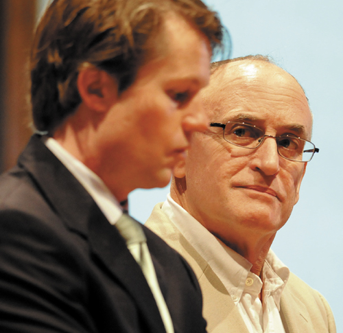 Former Monmouth Middle School fifth grade teacher Christopher B. Brown, 55, right, listens Tuesday to his attorney, Michael Whipple, during an appearance at Kennebec County Superior Court in Augusta on a charge that Brown had school laptops loaded with photographs depicting nude children in sexually explicit positions. Brown, of Monmouth, entered a not guilty plea to the charge of possession of sexually explicit materials of children under age 12.