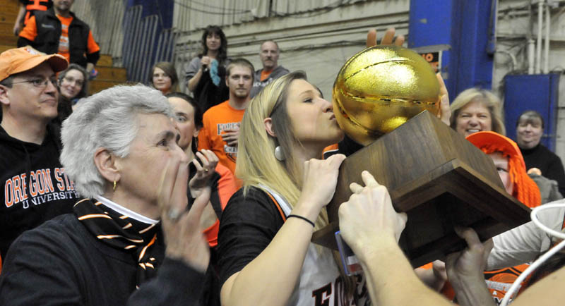 Staff photo by Michael G. Seamans PARTY TIME: Forest Hills High School's Evan Worster (23) celebrates with fans after defeating Central Aroostook 55-48 Saturday in the Class D State Championship game at the Bangor Auditorium.