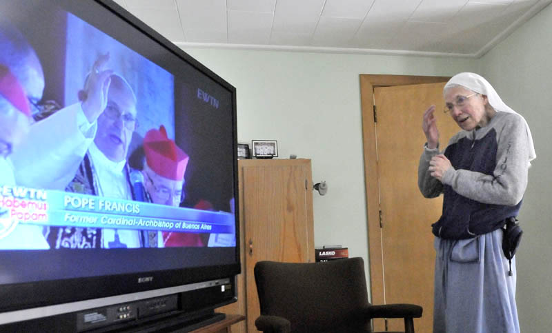 Sister Kathryn Kelm watches as the 265th pope is introduced at the Vatican Wednesday. Cardinal Jorge Mario Bergoglio from Argentina was elected, making him the first Jesuit and South American to be pope.