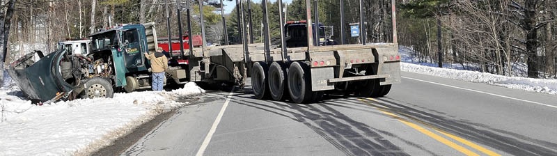 A logging truck involved in a collision with an SUV on US Route 2 also known as Canaan Road sits in the ditch with in Skowhegan Thursday. No serious injuries were reported.