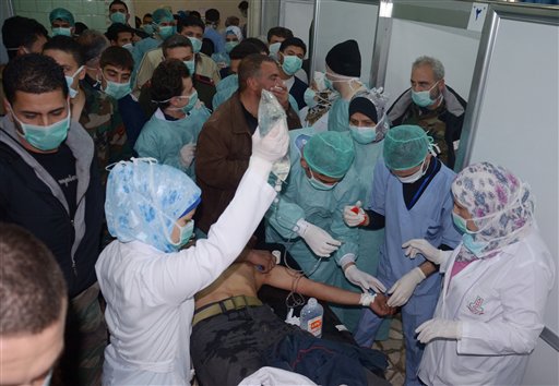In this photo released by the Syrian official news agency SANA, a Syrian victim who suffered an alleged chemical attack at Khan al-Assal village receives treatment by doctors at a hospital in Aleppo on Tuesday.