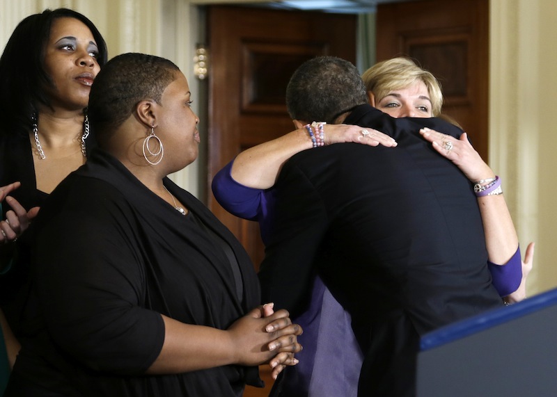 President Barack Obama hugs a woman in the East Room of the White House in Washington, Thursday, March 28, 2013, after he spoke about gun violence. The president was joined by what the White House said was mothers, law enforcement officials, victims of gun violence, who the White House did not want to name. (AP Photo/Carolyn Kaster)