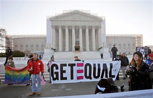 Demonstrators stand outside the Supreme Court in Washington on Tuesday.
