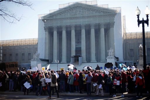 Demonstrators crowd the sidewalk outside the Supreme Court in Washington on Tuesday.