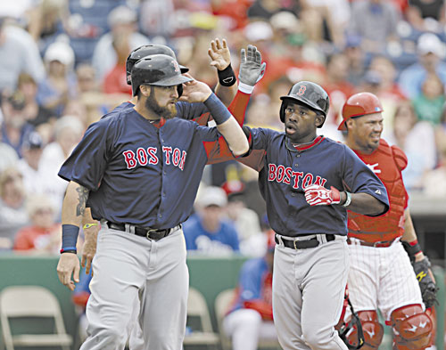 NICE JOB: Boston’s Will Middlebrooks, back, and Jonny Gomes, left, greet Jackie Bradley after he hit a second-inning, three-run home run off Philadelphia starting pitcher Cliff Lee in a spring training game Sunday in Clearwater, Fla.