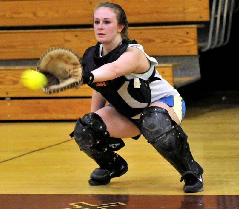 BACK AT IT: Nokomis Regional High School catcher Danielle George looks in a pitch at practice on Monday in Newport.