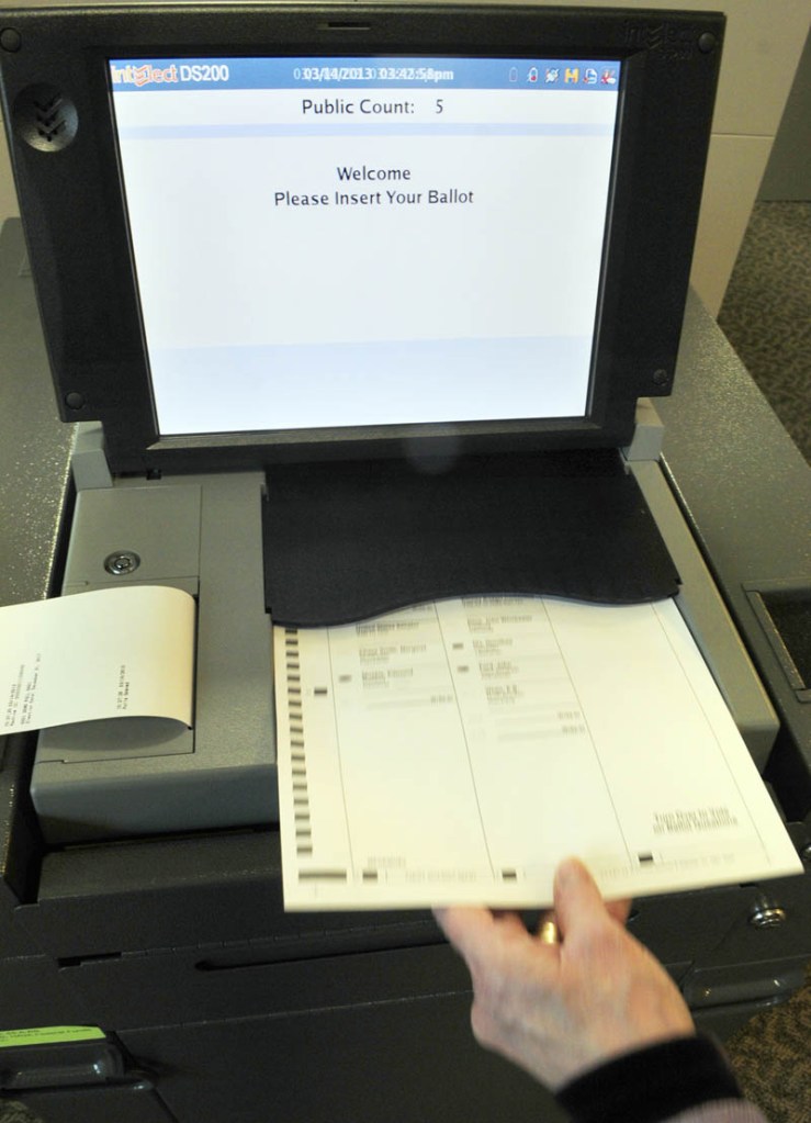 Deputy Secretary of State Julie Flynn demonstrates one of the the new, state-leased DS 200 tabulators on Thursday in the Cross Building in Augusta.