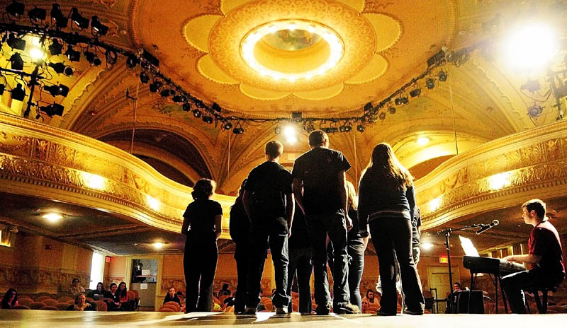Monmnouth Academy student Nikolas Foulke, right, accompanies the Choralites on piano as they rehearse "Some Nights" by Fun. on Thursday in the Cumston Hall theater in Monmouth. They will be a part of the Broadway 13 show on Friday at 7 p.m. The spring musical show will feature Broadway show tunes and other musical numbers according to teacher Judy Mank.