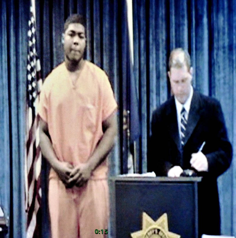 Thomas College student Eimel Evans, left, and his attorney Brad Grant, appear in a video conference with Judge Charles Dow in Waterville District Court on Wednesday. Evans is charged with attempted murder, gun possession and gang assault in New York City.